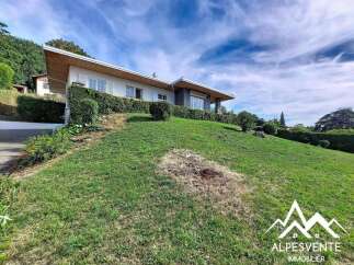 Discover this charming property nestled on a lush green hillside, offering a serene and picturesque setting.