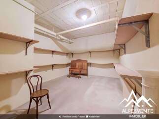 Discover ample storage solutions in this versatile room, featuring extensive shelving along multiple walls.