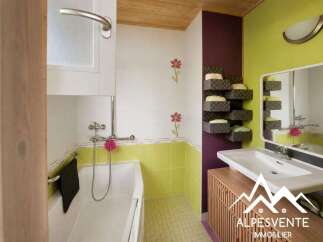 Discover this charming bathroom featuring a relaxing bathtub and a modern vanity with a spacious sink.