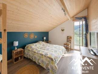 Discover this charming bedroom featuring a cozy bed with a nature-inspired duvet and a rustic wooden nightstand.