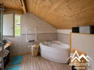 Experience ultimate relaxation in this charming bathroom featuring a luxurious corner bathtub, perfect for unwinding after a long day.