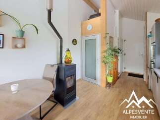 Experience cozy living in this charming space featuring a modern black wood-burning stove, perfect for warming up on chilly evenings.