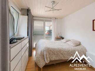 Discover this charming bedroom featuring a comfortable bed with a patterned duvet, complemented by a modern dresser and a television.