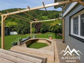 Enjoy outdoor living with this charming wooden pergola and multi-level deck, perfect for entertaining or relaxing in a serene natural setting.