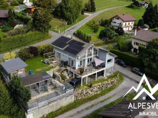 Discover this stunning property featuring a modern home with solar panels and a spacious deck, perfect for outdoor living.