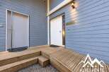 Welcome guests with this charming entrance featuring a ramp and stairs leading to two distinct doors.