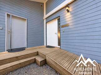 Welcome guests with this charming entrance featuring a ramp and stairs leading to two distinct doors.