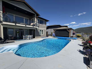 Enjoy the ultimate outdoor living experience with this stunning backyard oasis, featuring a sparkling in-ground swimming pool perfect for hot summer days.