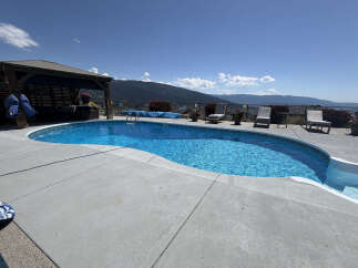 Escape to this stunning backyard oasis featuring a sparkling in-ground pool perfect for hot summer days.