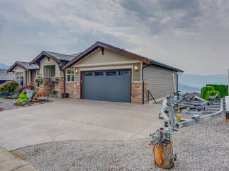Discover this stunning home featuring a spacious driveway leading to a modern garage.