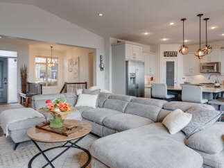 Experience modern living in this open-concept home, featuring a spacious sectional sofa perfect for entertaining.