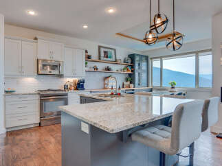 Experience luxury in this stunning kitchen featuring a spacious granite island perfect for entertaining.