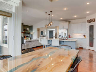 Experience modern living in this open-concept home featuring a stunning live-edge dining table with a resin river inlay, perfect for entertaining.