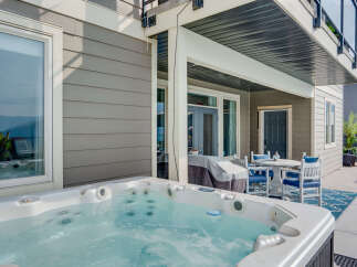 Enjoy ultimate relaxation in this stunning backyard oasis, featuring a luxurious hot tub perfect for unwinding.