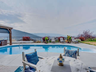 Escape to this stunning backyard oasis featuring a sparkling swimming pool and a relaxing spa, perfect for unwinding.