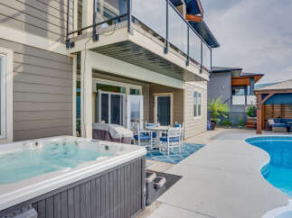 Enjoy ultimate relaxation in this backyard oasis featuring a luxurious hot tub and a sparkling swimming pool.