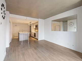 Experience modern living in this bright and airy open-concept space, featuring a sleek kitchen with stainless steel appliances and a central island perfect for casual dining.