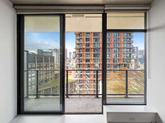 Experience breathtaking city views from this stunning apartment featuring expansive floor-to-ceiling windows and a private balcony.