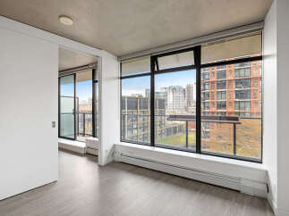 Experience modern urban living in this spacious apartment featuring expansive windows that flood the space with natural light and offer stunning city views.