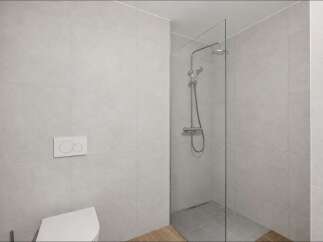 Experience modern comfort in this bathroom featuring a sleek glass-enclosed shower with a rainfall showerhead.