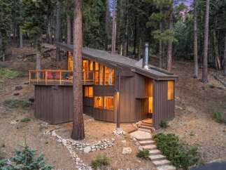 Nestled amidst towering pine trees, this charming cabin offers a serene mountain retreat.