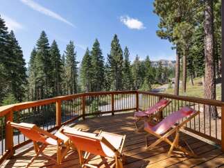 Enjoy breathtaking mountain views from this spacious wooden deck, perfect for relaxing or entertaining.