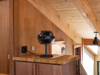 Experience the warmth of natural wood finishes throughout this home, from the paneled walls to the exposed ceiling beams.