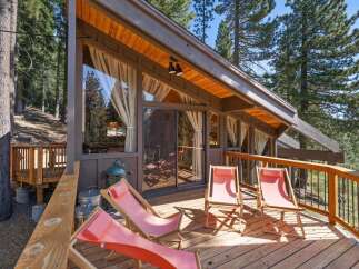 Enjoy the serene mountain lifestyle from this charming cabin's expansive deck, perfect for outdoor relaxation and entertaining.