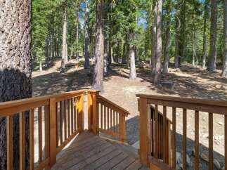 Step onto the charming wooden deck and immerse yourself in the serene beauty of this wooded retreat.