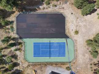 Enjoy your own private tennis court, complete with a protective cover for year-round use.