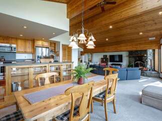 Experience open-concept living in this stunning home, featuring a spacious dining area adjacent to a well-appointed kitchen with ample cabinetry and a large island.