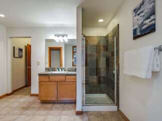 This spacious bathroom features a large vanity with ample counter space and storage, perfect for organizing your essentials.