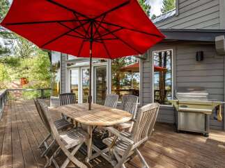Enjoy outdoor living on this spacious wooden deck, perfect for entertaining or relaxing.