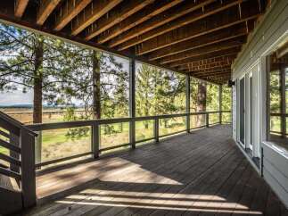 Enjoy breathtaking views from this expansive covered deck, perfect for outdoor entertaining or quiet relaxation.