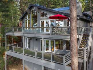 Experience luxury mountain living in this stunning home, featuring expansive multi-level decks perfect for entertaining or enjoying the serene forest views.