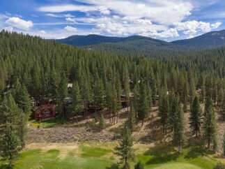 Nestled amidst a dense pine forest, this property offers a serene mountain retreat.