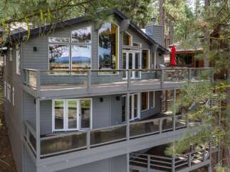 Experience breathtaking mountain views from this stunning multi-level home nestled among tall pine trees.
