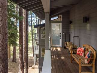 Enjoy the serene mountain lifestyle with this charming home featuring a spacious covered porch perfect for relaxing.