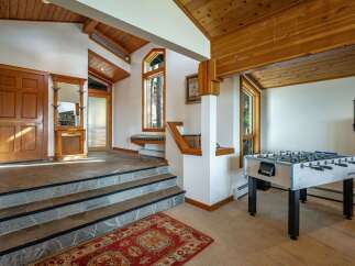 Step into this inviting entryway featuring a grand wooden door and a charming built-in bench beneath a unique corner window.