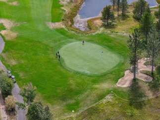 Experience the ultimate golf lifestyle with this stunning aerial view of a meticulously maintained golf course.
