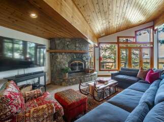 Experience cozy living in this stunning mountain retreat, featuring a magnificent stone fireplace as the centerpiece of the spacious living area.