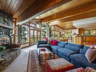 Experience rustic charm and breathtaking mountain views in this stunning living room.