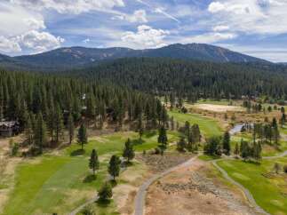 Experience the ultimate mountain lifestyle with this stunning property nestled amidst a lush pine forest and a pristine golf course.
