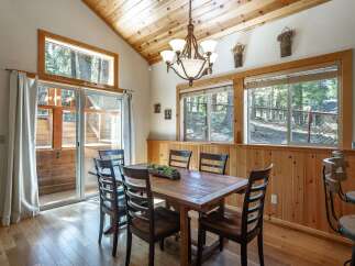 Experience rustic charm in this dining area featuring a beautiful wooden table and chairs, perfect for intimate gatherings.