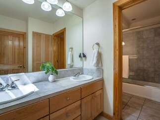 This charming bathroom features a double vanity with ample counter space and storage, perfect for busy mornings.