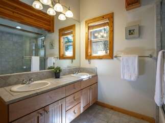 This charming bathroom features a spacious double vanity with ample counter space and storage, perfect for any household.