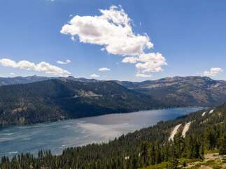 Experience breathtaking lakefront living with this stunning property offering panoramic views of the serene blue waters and surrounding majestic mountains.