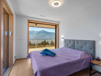 Experience breathtaking mountain views from this stunning bedroom, featuring a large sliding glass door that opens to a private balcony.