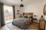 Experience cozy mountain living in this charming bedroom, featuring a rustic wooden headboard and plush bedding.