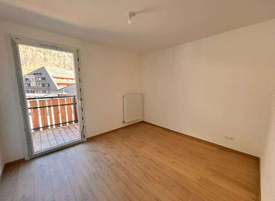 Discover this bright and airy room featuring a large glass door that opens to a charming balcony with scenic views.